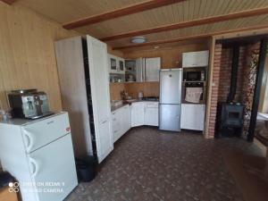 a kitchen with white appliances and white cabinets at Stanica Karpacka 4x4 in Mohnate