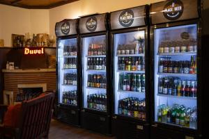 a group of refrigerators filled with bottles of beer at Bed & Breakfast The Place 2 Beer in Bullange