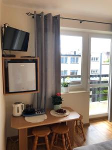 a room with a desk with a computer and a window at Pensjonat Klaudia in Ostrowo