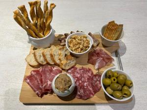 a cutting board with different types of meats and cheese at Maisonnette Saint Marcel Le petit Pitolat in Saint-Marcel +3 photos
