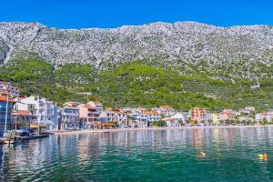 a group of houses on the shore of a body of water at Apartments Turan Centrally Located with Free Parking in Igrane