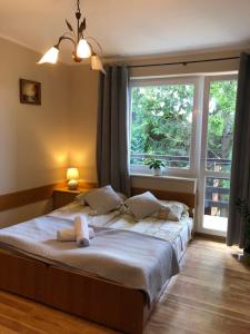 a bedroom with a bed with a teddy bear on it at Pensjonat Klaudia in Ostrowo