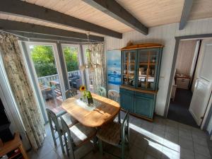 a dining room with a wooden table and chairs at Wildgans 85 in Mirow