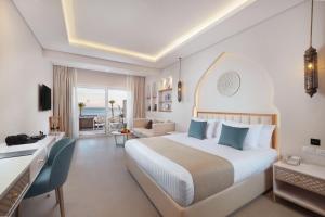 A bed or beds in a room at Sunrise Remal Beach Resort
