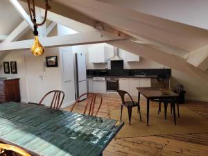 a kitchen and dining room with a table and chairs at le marais in Romans-sur-Isère