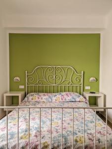 a bedroom with a bed with a green wall at Country House 3Quatrì in Corropoli +27 photos