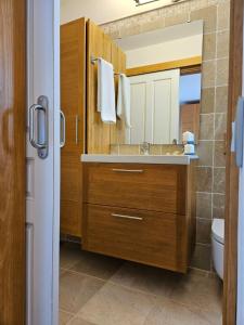 a bathroom with a sink and a mirror at Apartamento (Cotillo Mar) con vistas al Mar in Cotillo +50 photos