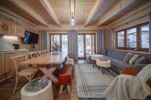 a living room with a couch and a table at Apartamenty Kozica&Jeleń in Witów