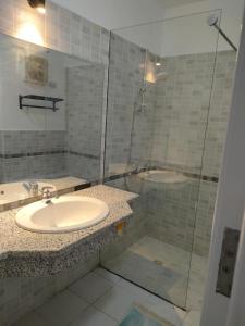a bathroom with a sink and a shower at comfort marina 5 apartment,s in Hurghada