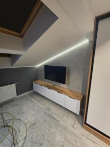 a living room with a flat screen tv on a wall at Centrum Jacuzzi prywatny parking klimatyzacja 5 in Radom