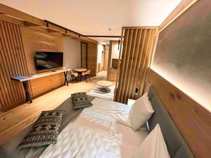 a bedroom with a bed with pillows on it at Apartment Vučko Lux C334 Private host in Jahorina