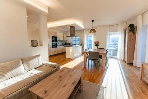 a living room with a couch and a table at Exklusiv Apartment Trattberg in Vöcklabruck