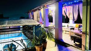 a house with a patio with plants and purple lights at Hotel Poonam Pushkar in Pushkar