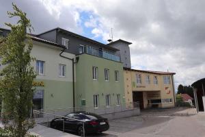 a black car parked in front of a building at Exklusiv Apartment Trattberg in Vöcklabruck