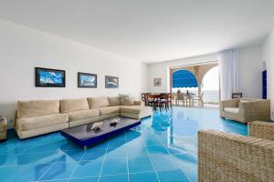 a living room with blue floors and a couch at AMORE RENTALS - Villa Marti in Massa Lubrense