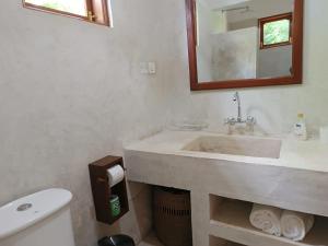a bathroom with a sink and a toilet and a mirror at Peace and Love Garden in Mto wa Mbu +43 photos
