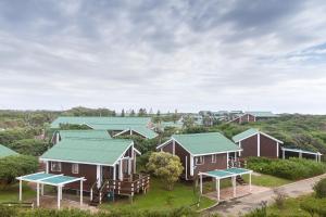 an aerial view of houses with green roofs at Pine Lodge Resort in Port Elizabeth