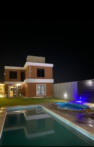 a house with a swimming pool in front of a house at Complejo Bru-Mar in Los Olivares
