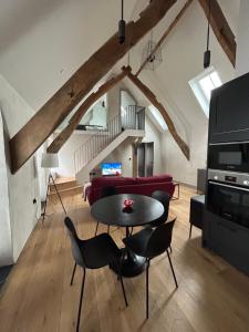 a living room with a table and chairs at 2 Cruck Cottage, Cowbridge in Cowbridge