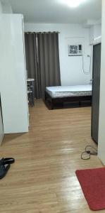 a hospital room with a bed and a wooden floor at Amhiel's Condo Rental Services in Minglanilla