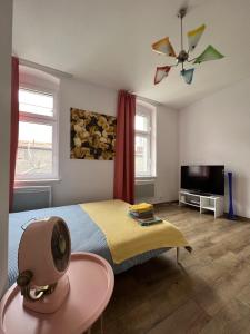 a bedroom with a bed and a ceiling fan at Apartment Katowice Center - Słowackiego in Katowice
