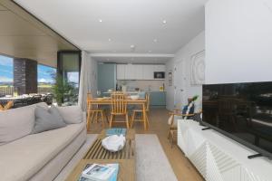 a living room with a white couch and a table at 14 An Garth in Hayle