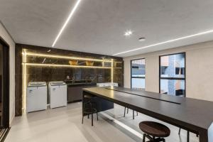 a kitchen with a ping pong table and appliances at Beach Haus #05 - Studio com Jacuzzi por Carpediem in João Pessoa