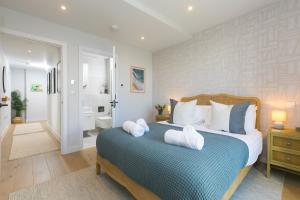 a bedroom with a bed with white towels on it at 14 An Garth in Hayle