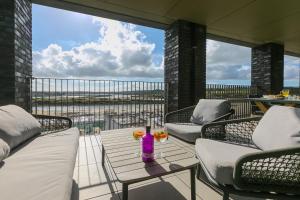 a patio with chairs and a table with a vase on it at 14 An Garth in Hayle