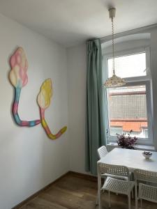a dining room with a table and a window at Apartment Katowice Center - Słowackiego in Katowice +2 photos