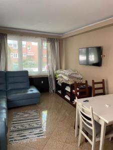 a living room with a couch and a table and a bed at Apartament Kołobrzeg in Kołobrzeg