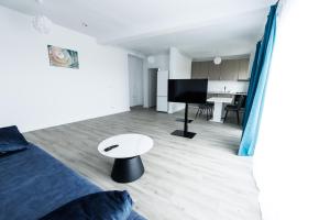 a bedroom with a bed and a table in a room at VISAJ Nova in Timişoara