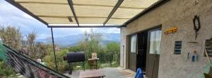 a room with a balcony with a view of the mountains at Frente a la sierra in Quebrada de los Pozos