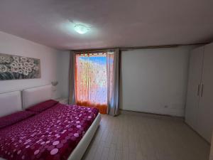 Postel nebo postele na pokoji v ubytování Villetta Ulivi CA7 sun terrace by Gardadomusmea