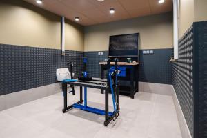 a gym with a treadmill in a room with a tv at Hob Orelle - Les 3 Vallées Val Thorens in Orelle