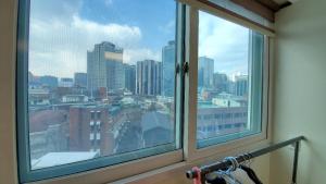 a window with a view of a city at Namsan Ville in Seoul