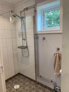 a shower with a glass door in a bathroom at Fully equipped country house with lake location in Eksjö