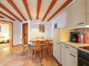a kitchen with a table and chairs in a room at Apartment Aphrodite West magnificent Eiger view in Grindelwald +32 photos
