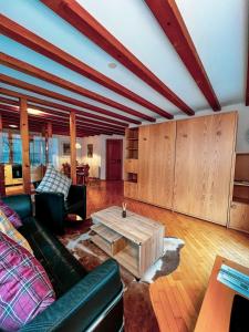 a living room with a couch and a coffee table at Apartment Aphrodite West magnificent Eiger view in Grindelwald