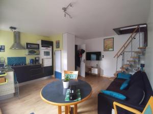 a living room with a couch and a table at Duplex 2 personnes, maximum 6, sans vis-à-vis in Aix-les-Bains