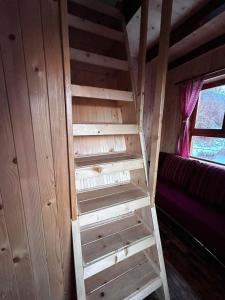 a wooden ladder in a room with a window at Country Villa MMMM-2-CampScepanovic in Mojkovac