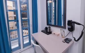 a phone sitting on a counter in a room with a window at The Exiles Hotel in Sliema