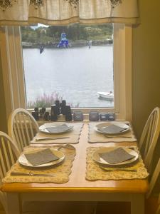 a table with a view of the water from a window at Hanøya- Vesterålen in Myrland