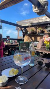 a glass of water sitting on a wooden table at Fedes house in Villa Gesell