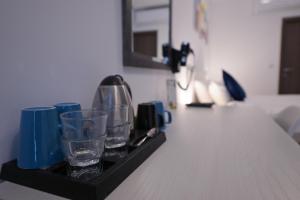 a black tray with glasses and cups on a table at The Exiles Hotel in Sliema