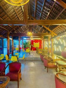 a restaurant with colorful chairs and tables and chairs at Sân Vườn Hotel Khánh Hòa in Ninh Hòa