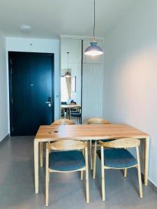 a wooden table with two chairs and a dining room at 1Br Feliz apartment ThanhMyLoi in Ho Chi Minh City