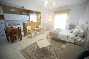 a bedroom with a bed and a kitchen and a table at 4keys House - Apartment 2 in Tripoli