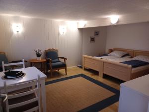a small bedroom with a bed and a chair at Ferienwohnung Dau I in Nübbel