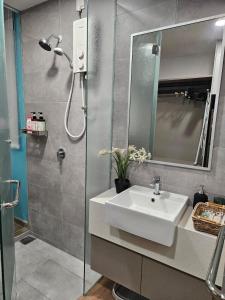 a bathroom with a sink and a shower at SerenityStayatRiveria KL Sentral in Kuala Lumpur